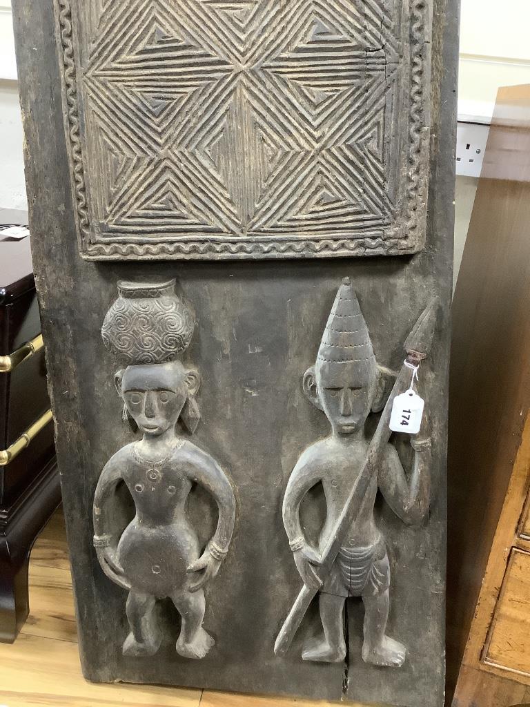 An African carved hardwood panel, width 42cm height 176cm